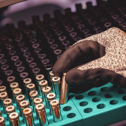 Person placing used device battery on tray to recycle